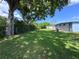 Expansive backyard with lush green grass, mature trees, and plenty of open space at 2331 Belleair Rd # 904, Clearwater, FL 33764