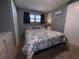 A carpeted bedroom with windows, closet, and bed with patterned quilt at 2331 Belleair Rd # 904, Clearwater, FL 33764