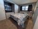 A carpeted bedroom with windows, closet, and bed with patterned quilt at 2331 Belleair Rd # 904, Clearwater, FL 33764