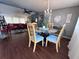 Stylish dining area with a chandelier, glass table, and chairs, with a view into the cozy living room at 2331 Belleair Rd # 904, Clearwater, FL 33764