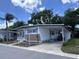 Charming manufactured home featuring a carport, covered patio, and neatly maintained landscaping at 2331 Belleair Rd # 904, Clearwater, FL 33764