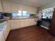 Bright kitchen featuring white cabinetry, practical appliances, and a sink under the window with a garden view at 2331 Belleair Rd # 904, Clearwater, FL 33764