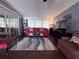 Cozy living room with a red sofa, decorative rug, and large windows, creating a welcoming atmosphere at 2331 Belleair Rd # 904, Clearwater, FL 33764