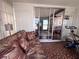 Comfortable sun room with tile floors, a sofa, and view into another room at 2331 Belleair Rd # 904, Clearwater, FL 33764