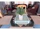Dining table with placemats, a leafy centerpiece, and views of a living space at 2331 Belleair Rd # 904, Clearwater, FL 33764