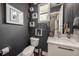 Stylish half-bathroom with modern fixtures, floating shelves, and decorative artwork at 2511 N Grady Ave # 82, Tampa, FL 33607
