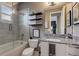 Bathroom with a tub and shower, granite vanity, and modern decor at 2511 N Grady Ave # 82, Tampa, FL 33607