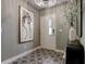 Inviting foyer featuring decorative tile flooring, modern light fixture, and stylish decor at 2511 N Grady Ave # 82, Tampa, FL 33607