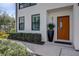 A modern front door with sidelight, contrasted with verdant landscaping, provides an inviting entrance at 2511 N Grady Ave # 82, Tampa, FL 33607