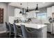 Modern kitchen with white cabinets, marble countertops, designer lighting, and bar seating at 2511 N Grady Ave # 82, Tampa, FL 33607