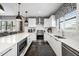 Bright, modern kitchen with white cabinetry, stainless steel appliances, a large island, and ample counter space at 2511 N Grady Ave # 82, Tampa, FL 33607