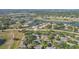 Aerial view of a community with ponds and green spaces, marked with a home icon at 2529 Lancaster Dr, Sun City Center, FL 33573