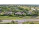 Aerial view of the property and neighborhood, showing proximity to golf course and lake at 2529 Lancaster Dr, Sun City Center, FL 33573
