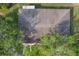 Overhead view of a residential roof, surrounded by lush trees and landscaping, offering privacy at 2529 Lancaster Dr, Sun City Center, FL 33573