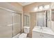 Bathroom features a shower, toilet, large mirror, and a vanity with sink at 2529 Lancaster Dr, Sun City Center, FL 33573