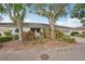 Exterior view of a home showcasing mature landscaping and a brick facade for a welcoming curb appeal at 2529 Lancaster Dr, Sun City Center, FL 33573