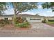 Charming home exterior featuring a two-car garage, well-manicured landscaping, and a paved driveway at 2529 Lancaster Dr, Sun City Center, FL 33573