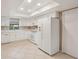 Well-lit kitchen featuring tile floors and modern appliances at 2529 Lancaster Dr, Sun City Center, FL 33573