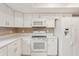 Modern kitchen boasts stainless steel appliances and ample counter space at 2529 Lancaster Dr, Sun City Center, FL 33573
