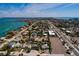 An aerial view shows the cozy home nestled in a vibrant neighborhood with a view of the bay at 340 83Rd Ave, St Pete Beach, FL 33706