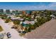 An aerial view of a light-blue home and its location near the Intracoastal Waterway and beach at 340 83Rd Ave, St Pete Beach, FL 33706