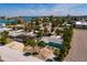Aerial shot of a light-blue home, located in a vibrant residential area near the water at 340 83Rd Ave, St Pete Beach, FL 33706