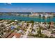 Drone view featuring a light-blue house with palm trees in a community surrounded by a bay and waterways at 340 83Rd Ave, St Pete Beach, FL 33706