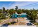 Aerial view of a turquoise house with palm trees, showing the home's layout and driveway at 340 83Rd Ave, St Pete Beach, FL 33706