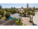 Aerial view of a light-blue single story home, showcasing its landscaping and proximity to community landmarks at 340 83Rd Ave, St Pete Beach, FL 33706