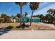 Charming turquoise house with a well-kept lawn and lush landscaping in a peaceful neighborhood at 340 83Rd Ave, St Pete Beach, FL 33706