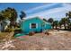 A single-story home with light blue exterior, complemented by mature palm trees in the yard at 340 83Rd Ave, St Pete Beach, FL 33706
