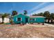 A single-story home with light blue exterior, complemented by palm trees in the yard at 340 83Rd Ave, St Pete Beach, FL 33706