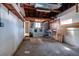 Unfinished basement laundry area with washer, dryer, exposed beams, and concrete floor ready for renovation at 340 83Rd Ave, St Pete Beach, FL 33706
