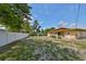 Spacious backyard with a white fence, mature trees, and an open patio at 3491 58Th N St, St Petersburg, FL 33710