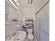 Compact bathroom with a sink, toilet, and glass door shower, plus towel storage at 3491 58Th N St, St Petersburg, FL 33710