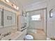 Clean bathroom featuring a shower-tub combo with sliding glass doors and a vanity sink at 3491 58Th N St, St Petersburg, FL 33710