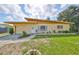 Charming single-story home with a well-maintained lawn and lovely landscaping at 3491 58Th N St, St Petersburg, FL 33710