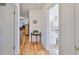 Hallway with hardwood floors that leads to a bathroom and other living spaces at 3491 58Th N St, St Petersburg, FL 33710