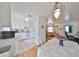 Open kitchen view showcasing white appliances, a dining area, and seamless access to the living room at 3491 58Th N St, St Petersburg, FL 33710