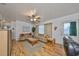 Cozy living room featuring hardwood floors, ceiling fan, two sofas, and natural light at 3491 58Th N St, St Petersburg, FL 33710