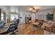 Spacious living area with hardwood floors that leads to a dining area and a view of the backyard at 3491 58Th N St, St Petersburg, FL 33710