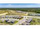 Aerial view of a suburban neighborhood with green spaces and tree lined horizon at 35260 Spruce Knob Ct, Dade City, FL 33525