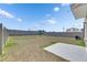 Large, fully-fenced backyard featuring a well-maintained lawn and concrete patio, perfect for outdoor gatherings at 35260 Spruce Knob Ct, Dade City, FL 33525
