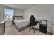 Comfortable bedroom featuring a queen bed, sleek desk, and large window with natural light, ideal for relaxation or work at 35260 Spruce Knob Ct, Dade City, FL 33525