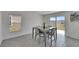 Dining area with modern table and chairs, natural light, and sliding glass door to yard at 35260 Spruce Knob Ct, Dade City, FL 33525