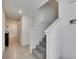 Hallway with tiled floor and carpeted stairs to the second floor at 35260 Spruce Knob Ct, Dade City, FL 33525
