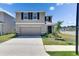 Two story home with neutral paint, black shutters, and well manicured lawn at 35260 Spruce Knob Ct, Dade City, FL 33525