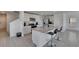 Open kitchen with island, stainless appliances, and tile floors at 35260 Spruce Knob Ct, Dade City, FL 33525