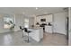 Open concept kitchen features a granite island with bar seating and modern appliances at 35260 Spruce Knob Ct, Dade City, FL 33525