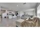 Open floor plan with modern kitchen, bar seating, living room, and dining area at 35260 Spruce Knob Ct, Dade City, FL 33525